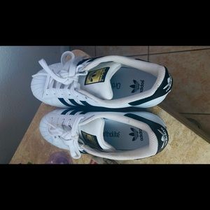 Black and white shelltoe adidas.